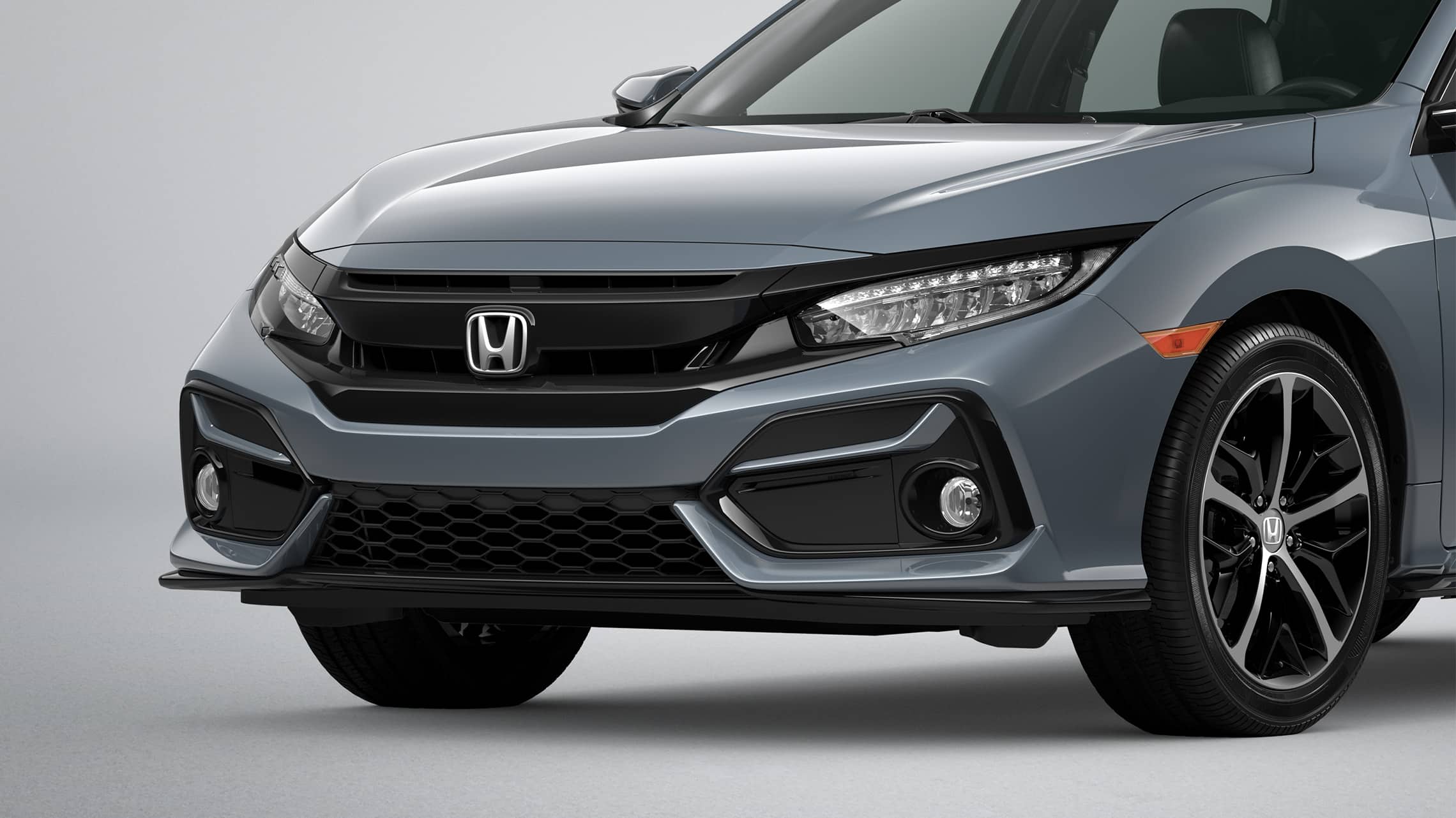 Front driver-side close-up view of the 2021 Honda Civic Sport Touring Hatchback in Sonic Gray Pearl.