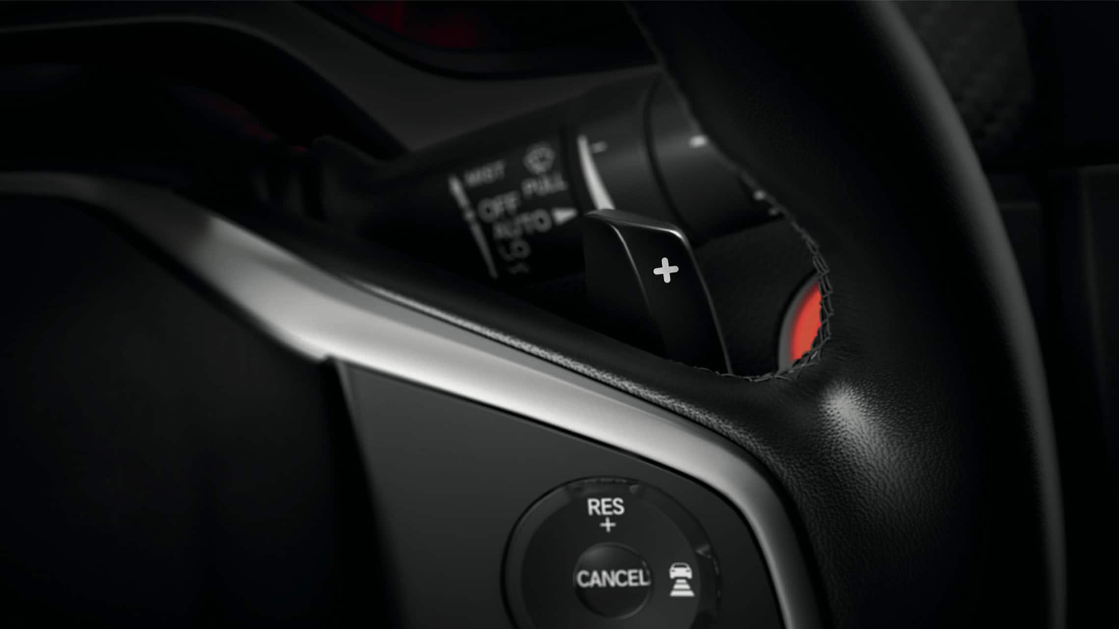 Steering wheel-mounted paddle shifter detail on the 2021 Honda Civic Sport Touring Hatchback.